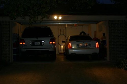 2006 Lincoln Navigator Ultimate and 2005 Cadillac DTS Night View of garage.